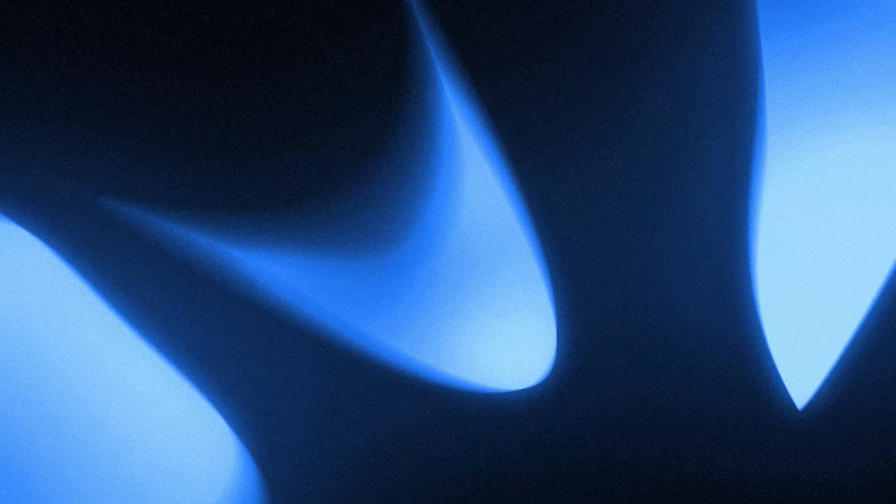 Abstract close-up of smooth, flowing blue and black shapes with soft gradients.