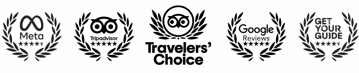 Five black award badges with laurel wreaths and five-star ratings from Meta, Tripadvisor, Travelers' Choice, Google Reviews, and Get Your Guide.