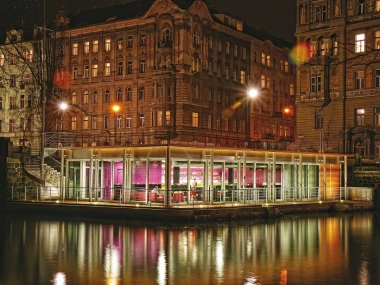 Jazz Dock venue illuminated beside the Vltava river at night