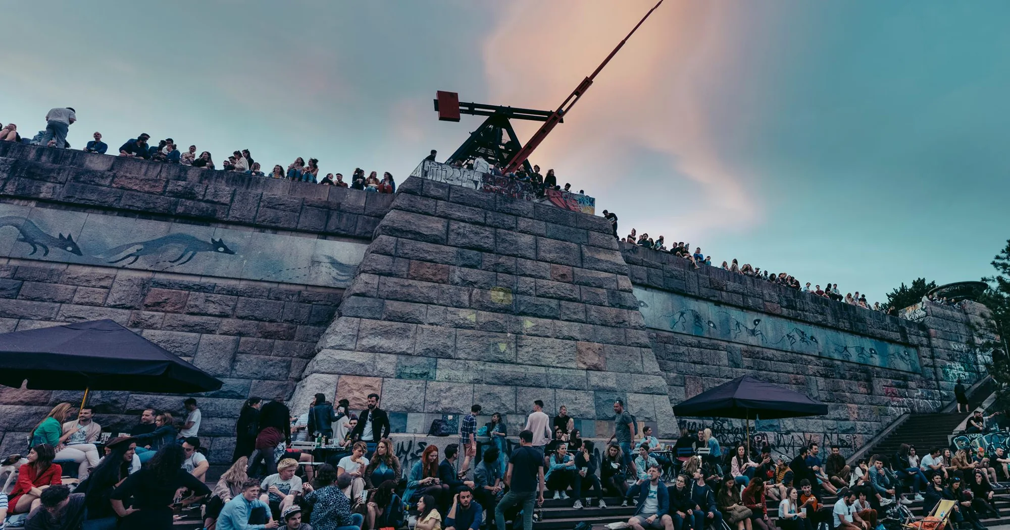 Seasonal evening crowd below the Prague Metronome at Stalin Letná
