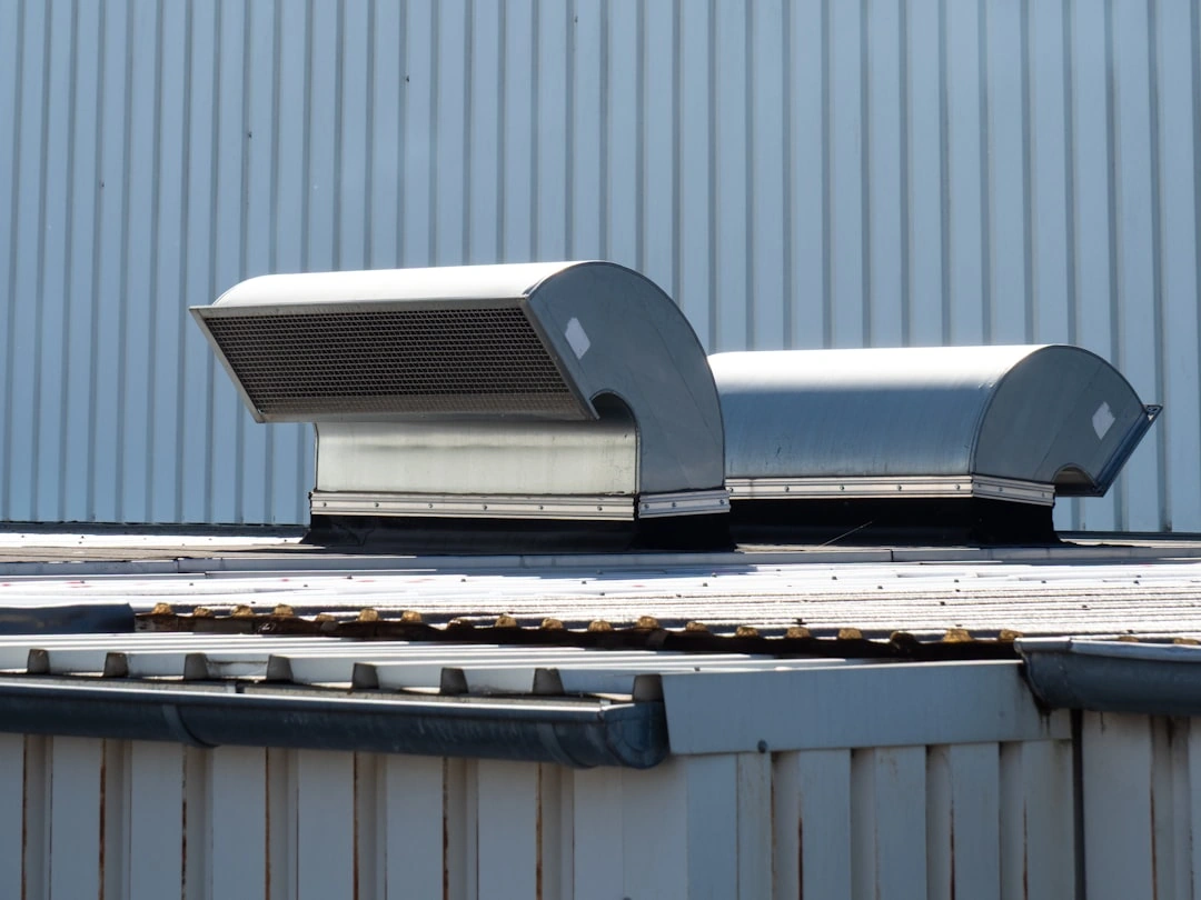 hail-damaged condenser coils on commercial rooftop HVAC unit