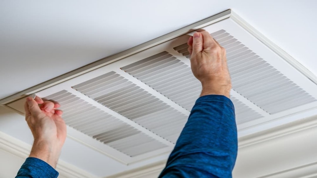 Technician performing AC maintenance on a residential system Technician performing AC maintenance on a residential system