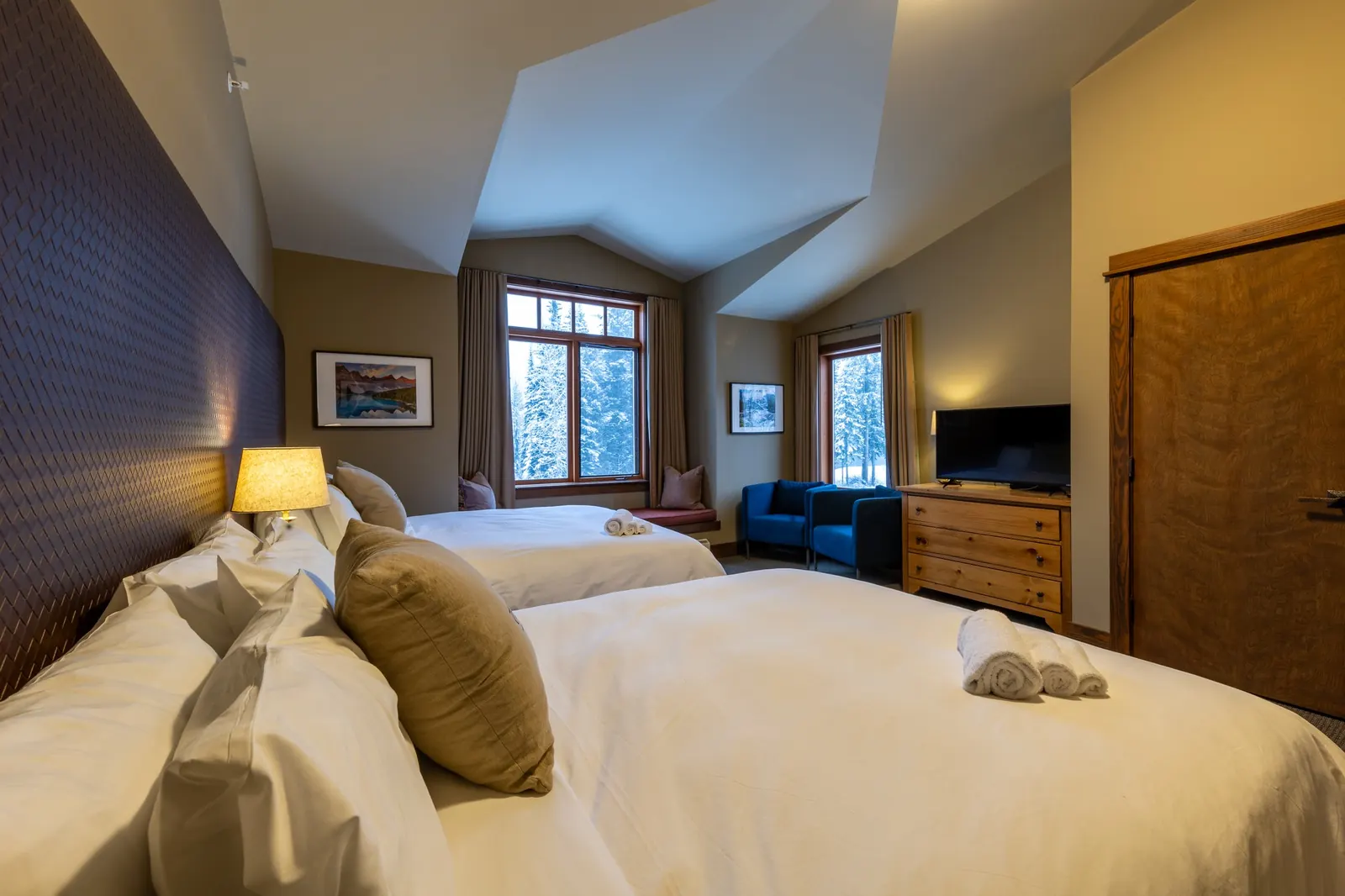 Two-queen guestroom with a vaulted ceiling