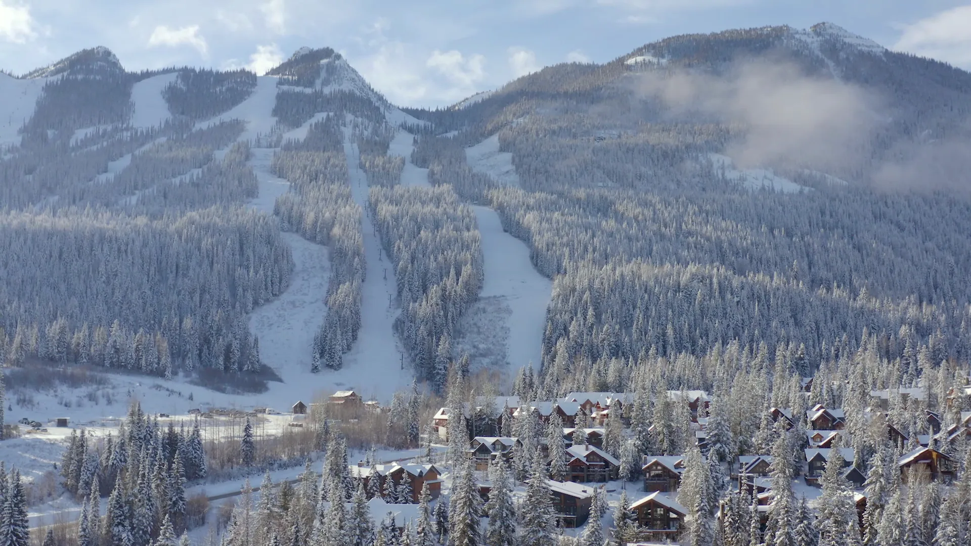 Snow-covered resort village beneath the Kicking Horse ski mountain