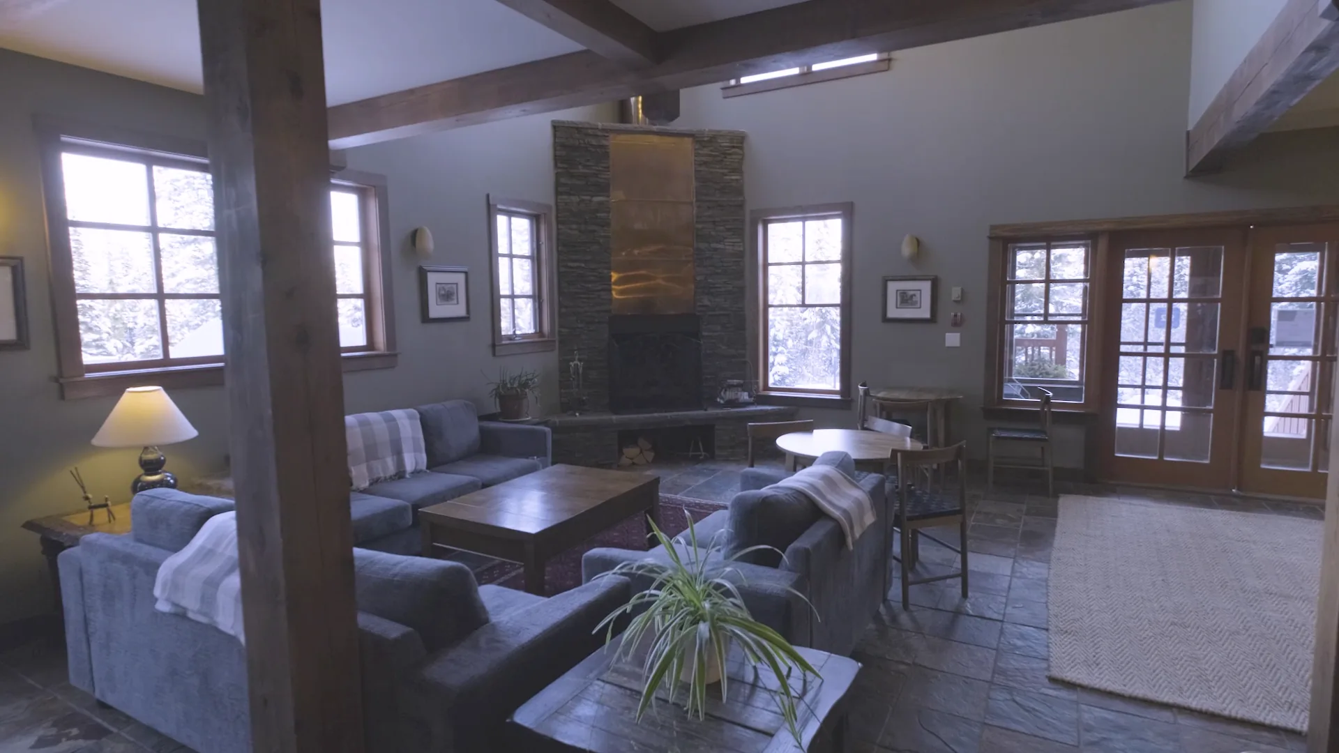 Shared lounge with blue seating and an unlit fireplace