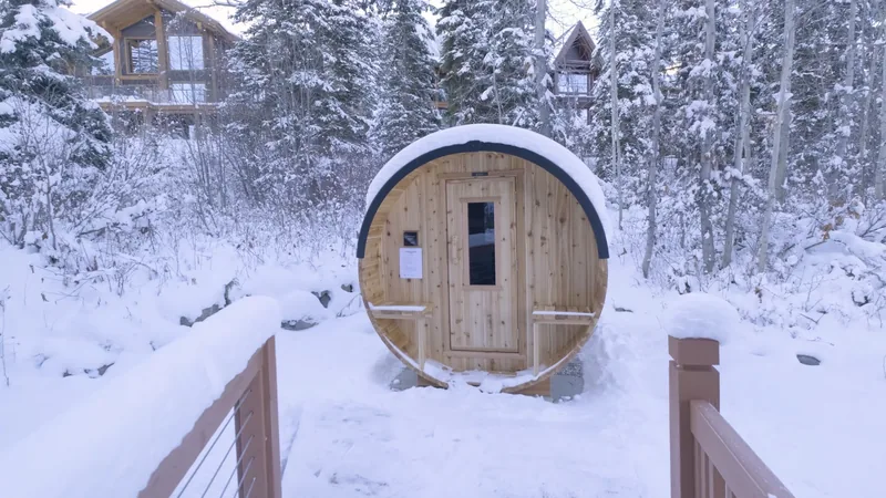 Snowy wooden approach to the outdoor barrel sauna