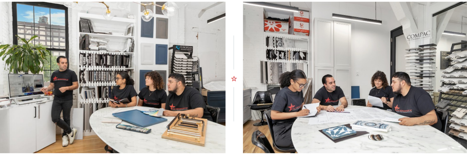 Four people in black t-shirts discussing design plans around a white marble table in a bright room with samples and catalogs on shelves.