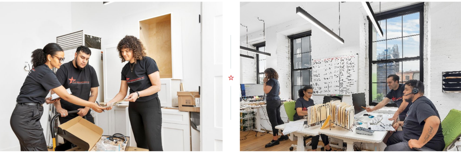 Team members in matching black t-shirts collaborate in a modern office setting with white walls, large windows, and organized desks with files and computers.