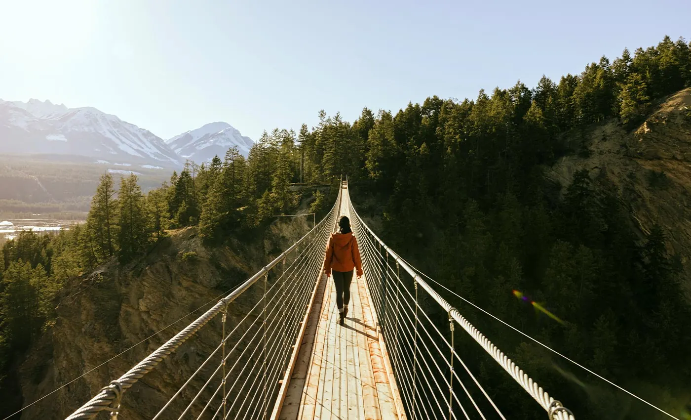 Visitors walking across a Golden Skybridge suspension bridge