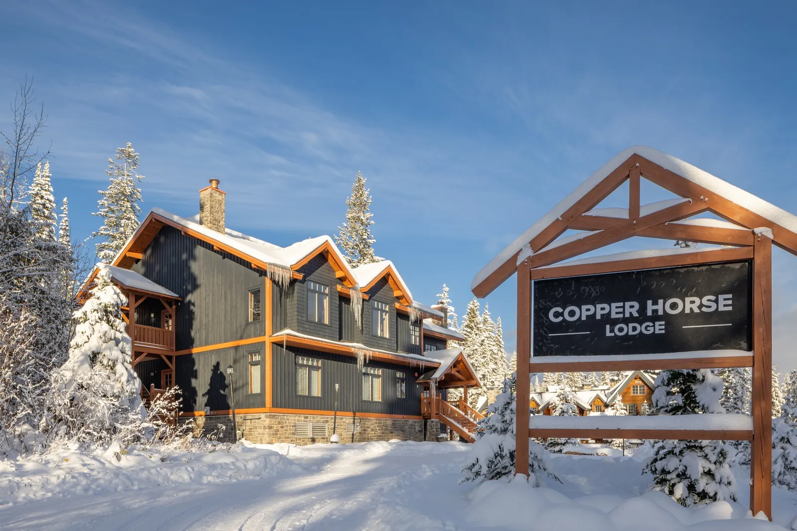 Copper Horse Lodge entrance sign in winter