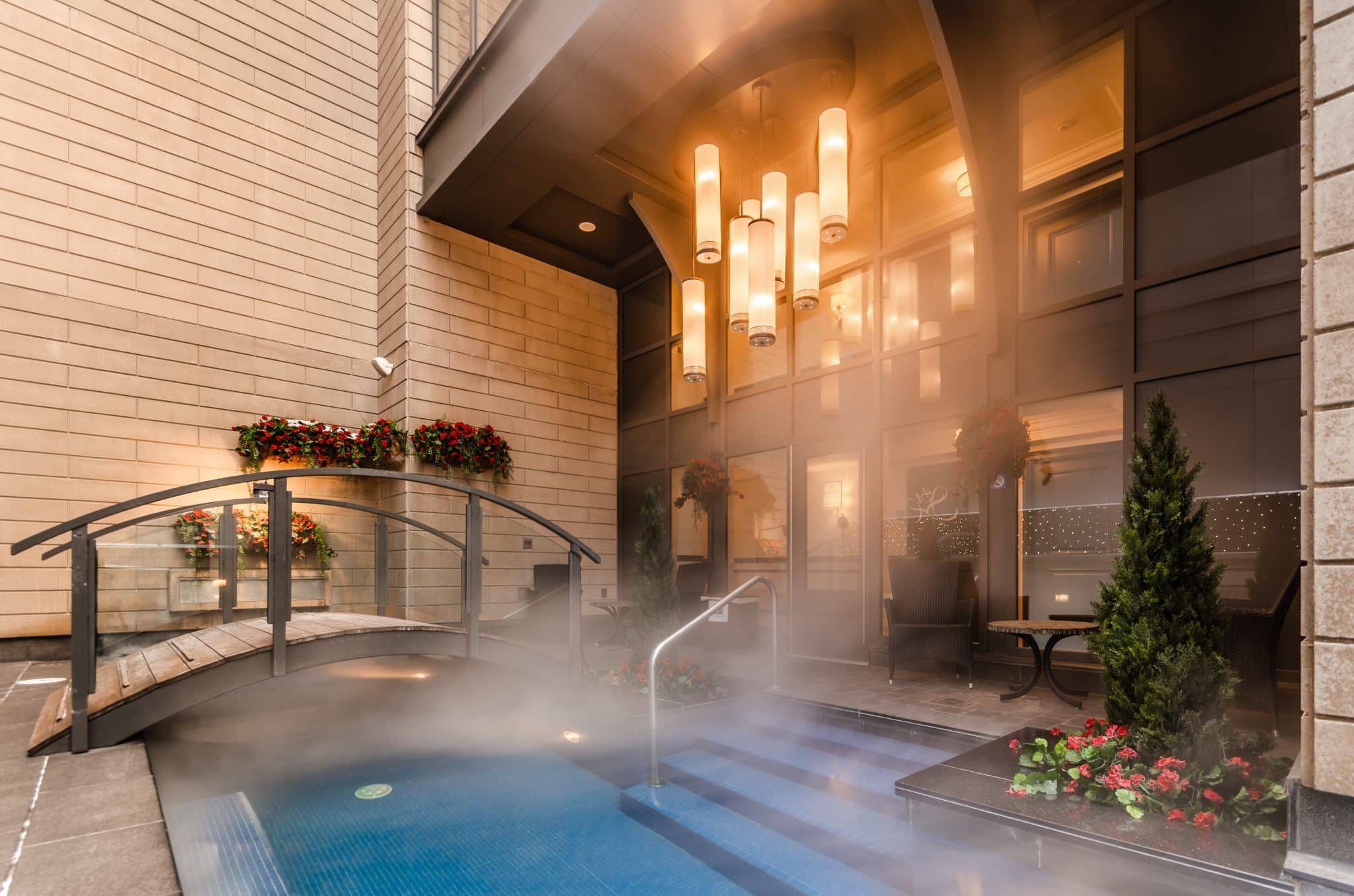 Steaming outdoor whirlpool and footbridge at The Metcalfe Hotel Montreal