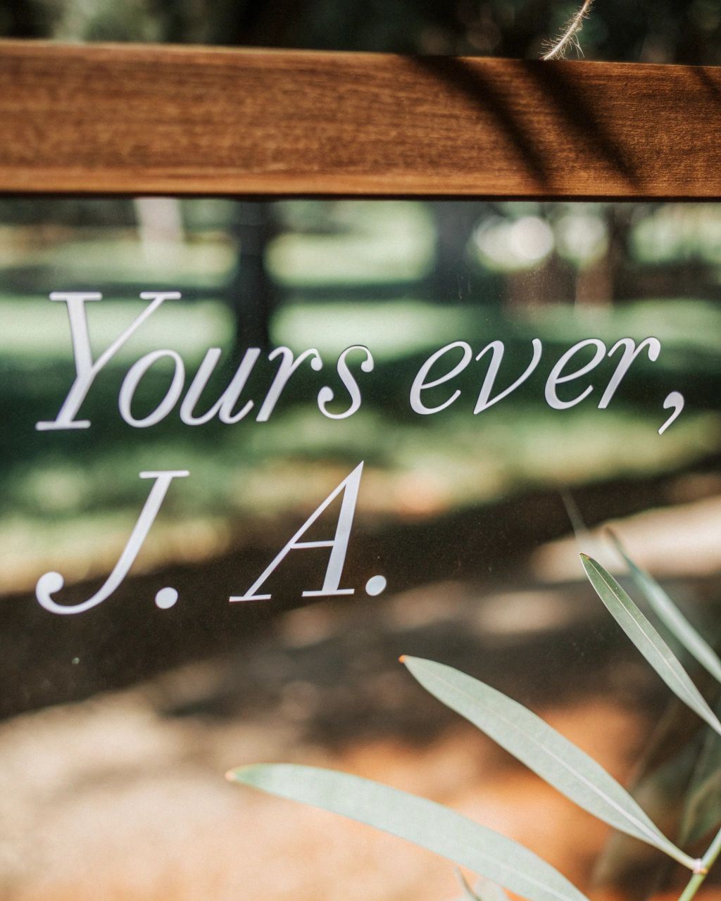 Green leaves background with the text “J.A. Forever,” honoring and commemorating Jane Austen’s enduring literary legacy.