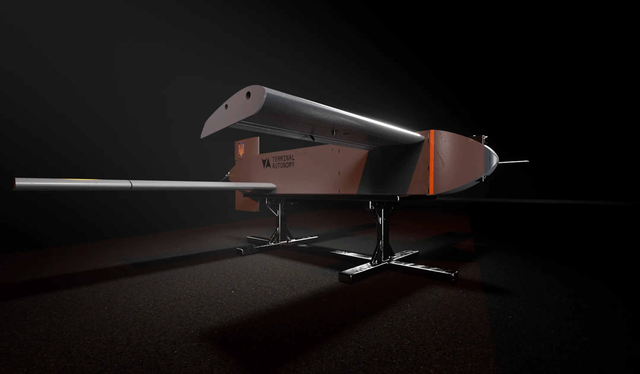 Side view of a brown autonomous drone with a long silver wing and two black stands under it on a dark background.