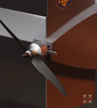 Close-up of a silver aircraft propeller attached to a red and gray plane nose.