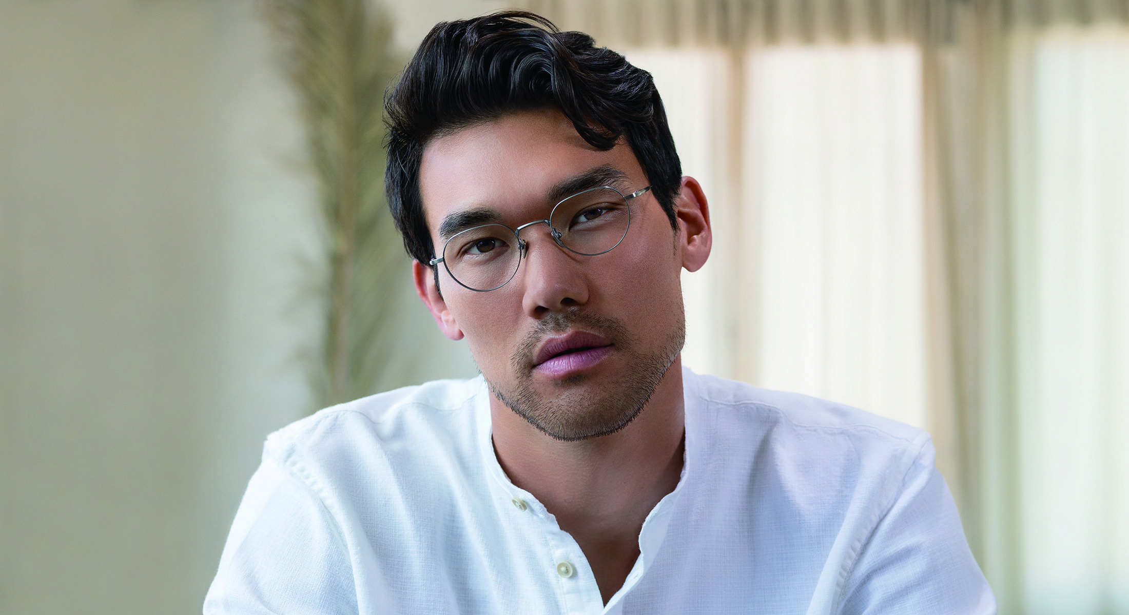 A man wearing Masunaga frames