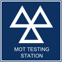 Blue road sign with three white triangles and text 'MOT TESTING STATION'.