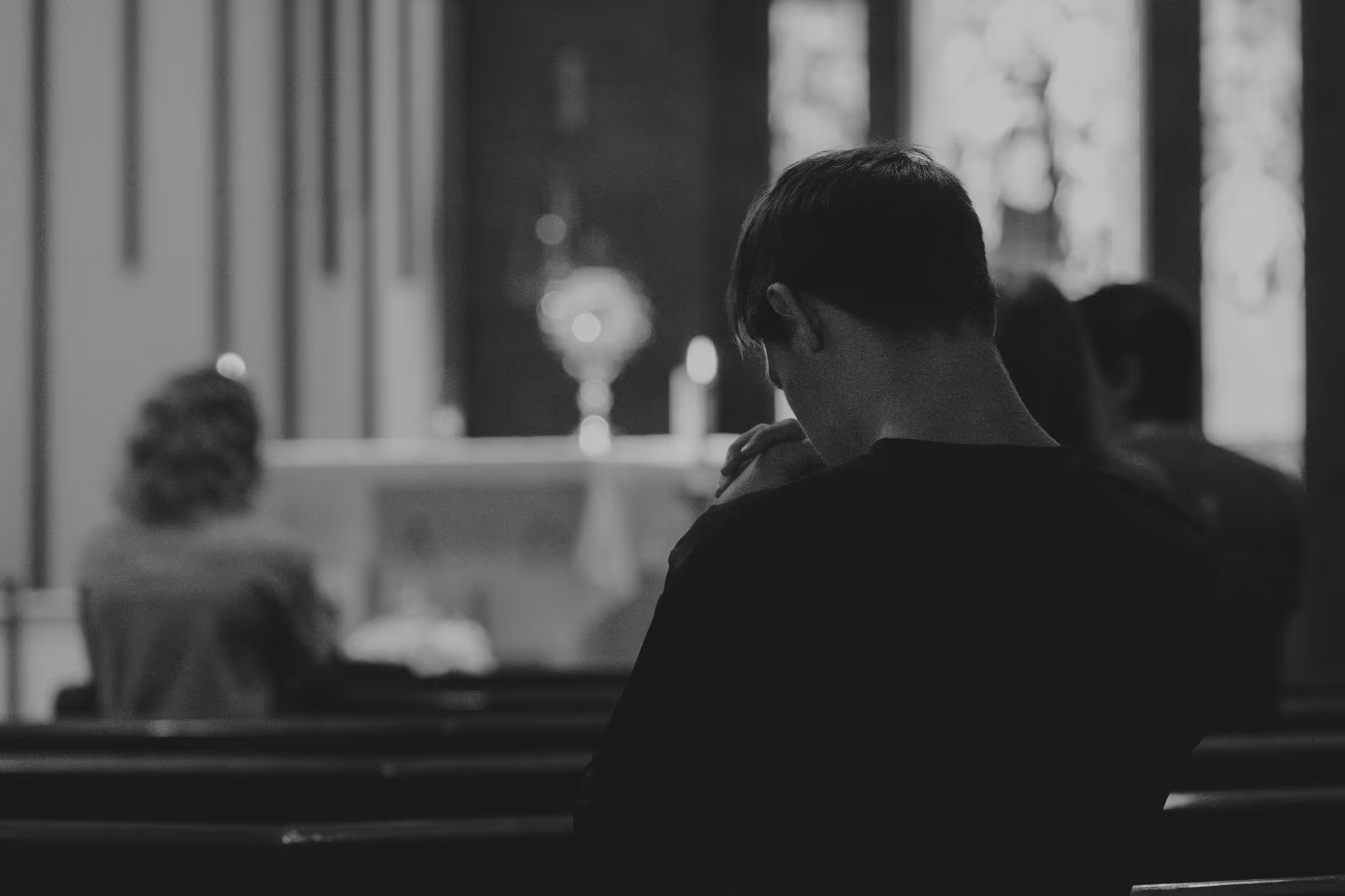 Worshipers praying during Eucharistic adoration inside a Catholic church