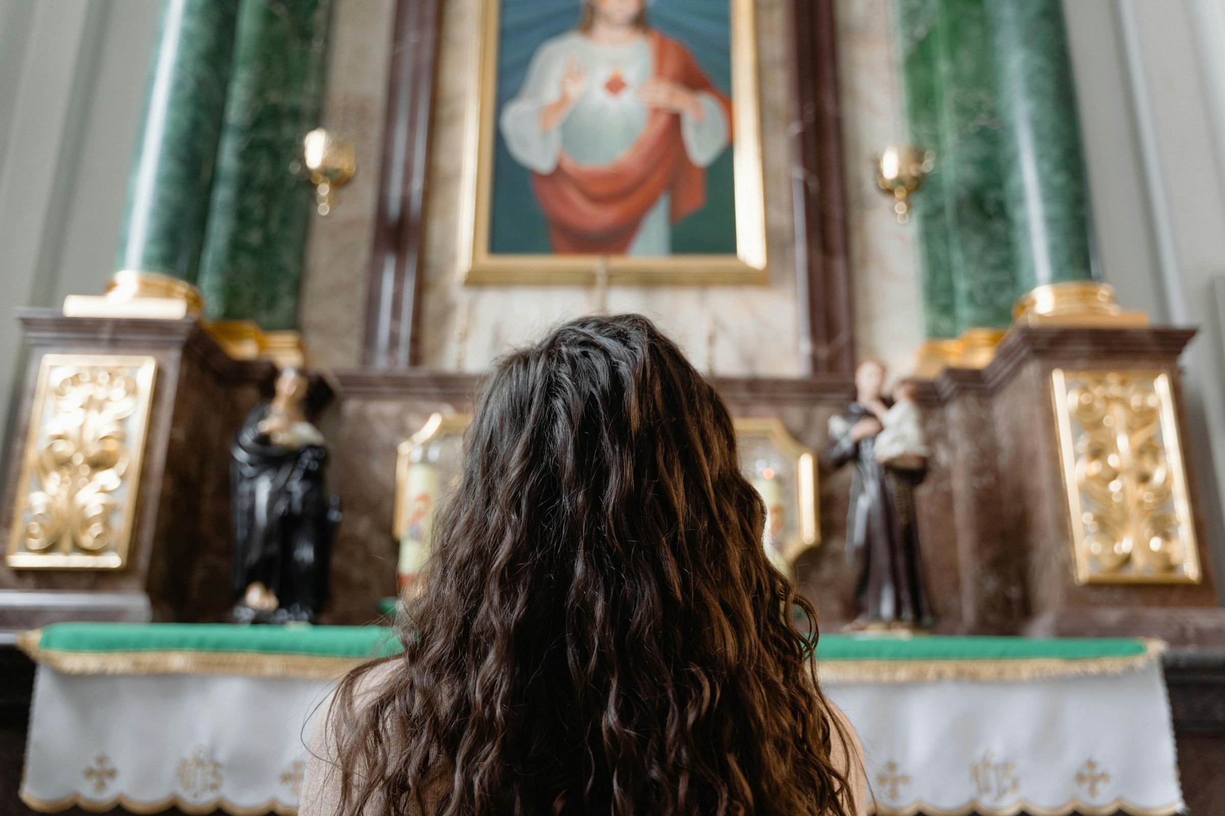 Young woman kneeling in front of an altar