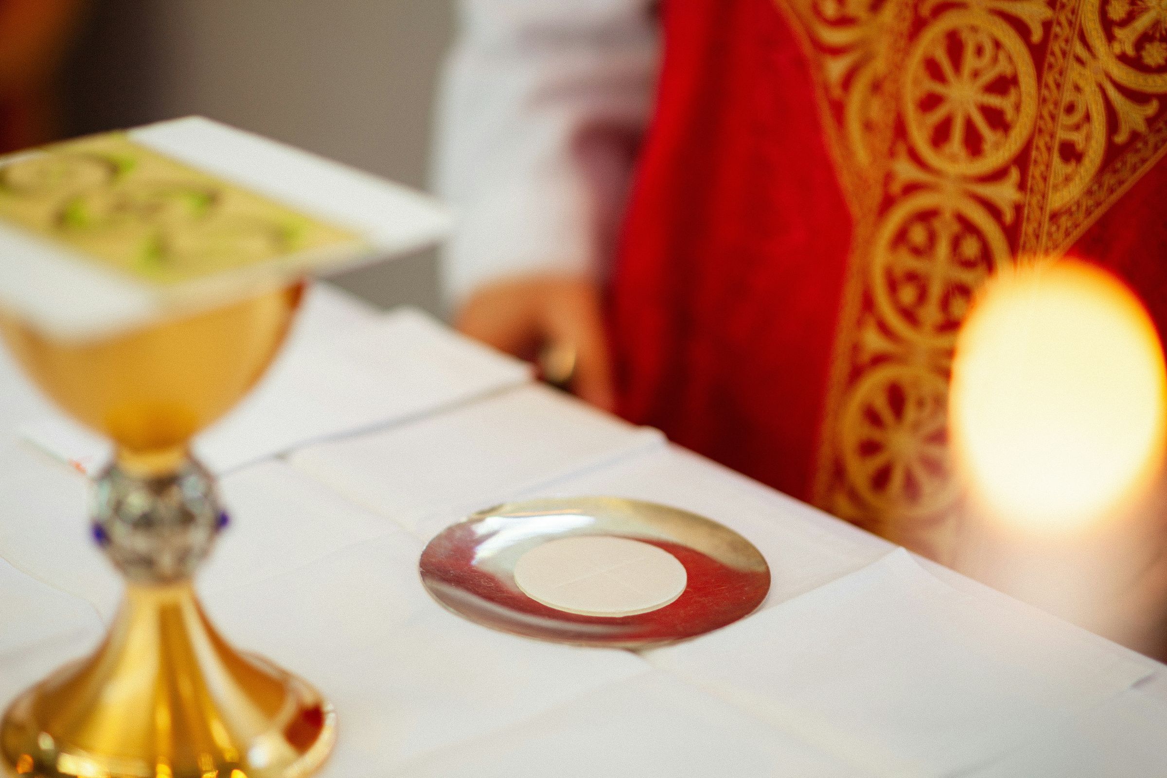 Close-up of the Communion host on the paten during the Consecration at Mass
