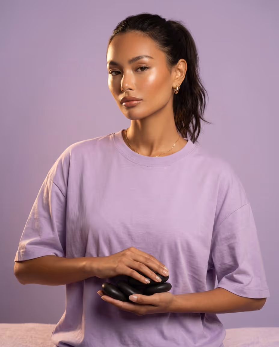 Massage therapist holding hot stones
