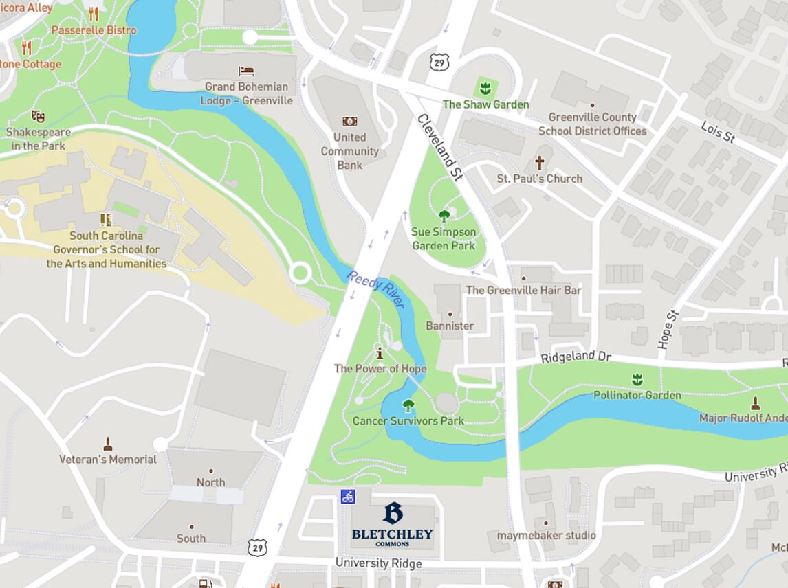 Map showing Bletchley Commons, surrounding parks including Cancer Survivors Park, Sue Simpson Garden Park, Pollinator Garden, the Reedy River, local landmarks, streets, and nearby businesses in Greenville.