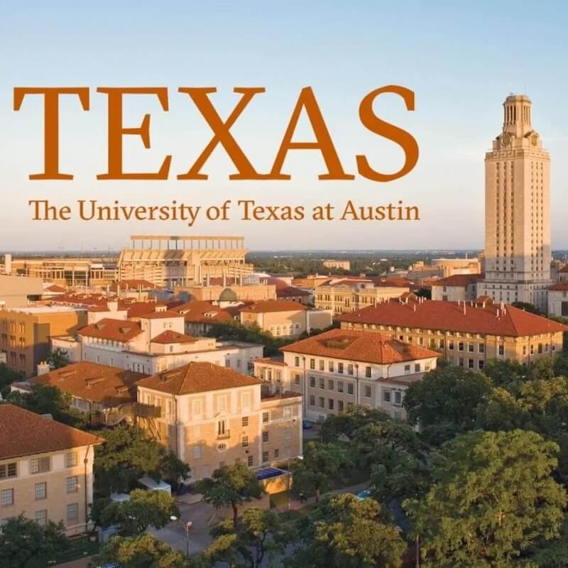 Aerial view of The University of Texas at Austin campus with the iconic UT Tower and football stadium at sunset.