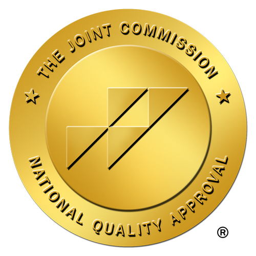 Gold seal with the text 'The Joint Commission National Quality Approval' surrounding a geometric logo.