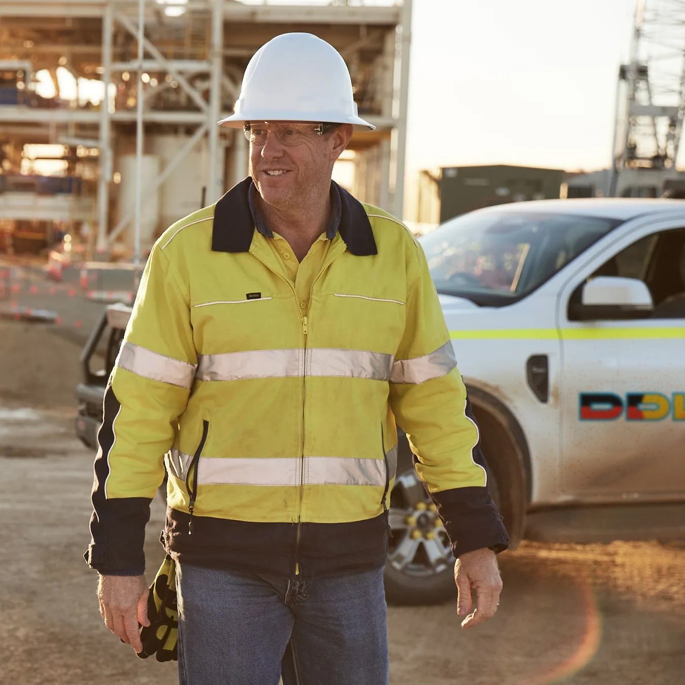 Worker with fliit vehicle in the background