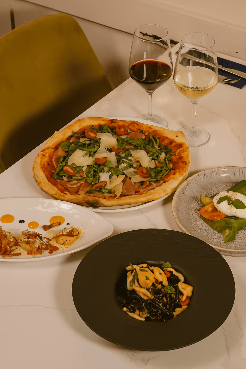 Pizza, pasta, salads on table