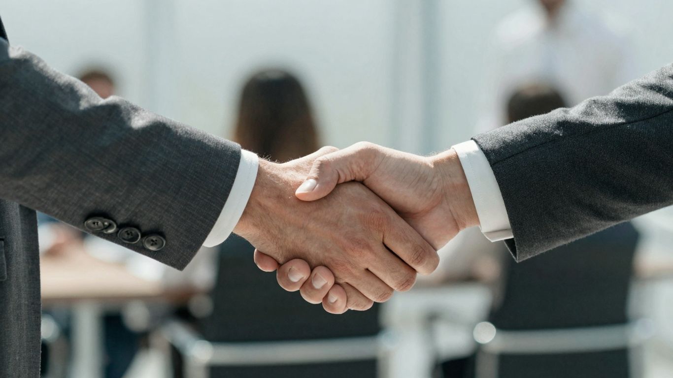 Marketing and sales hands shaking in collaboration.