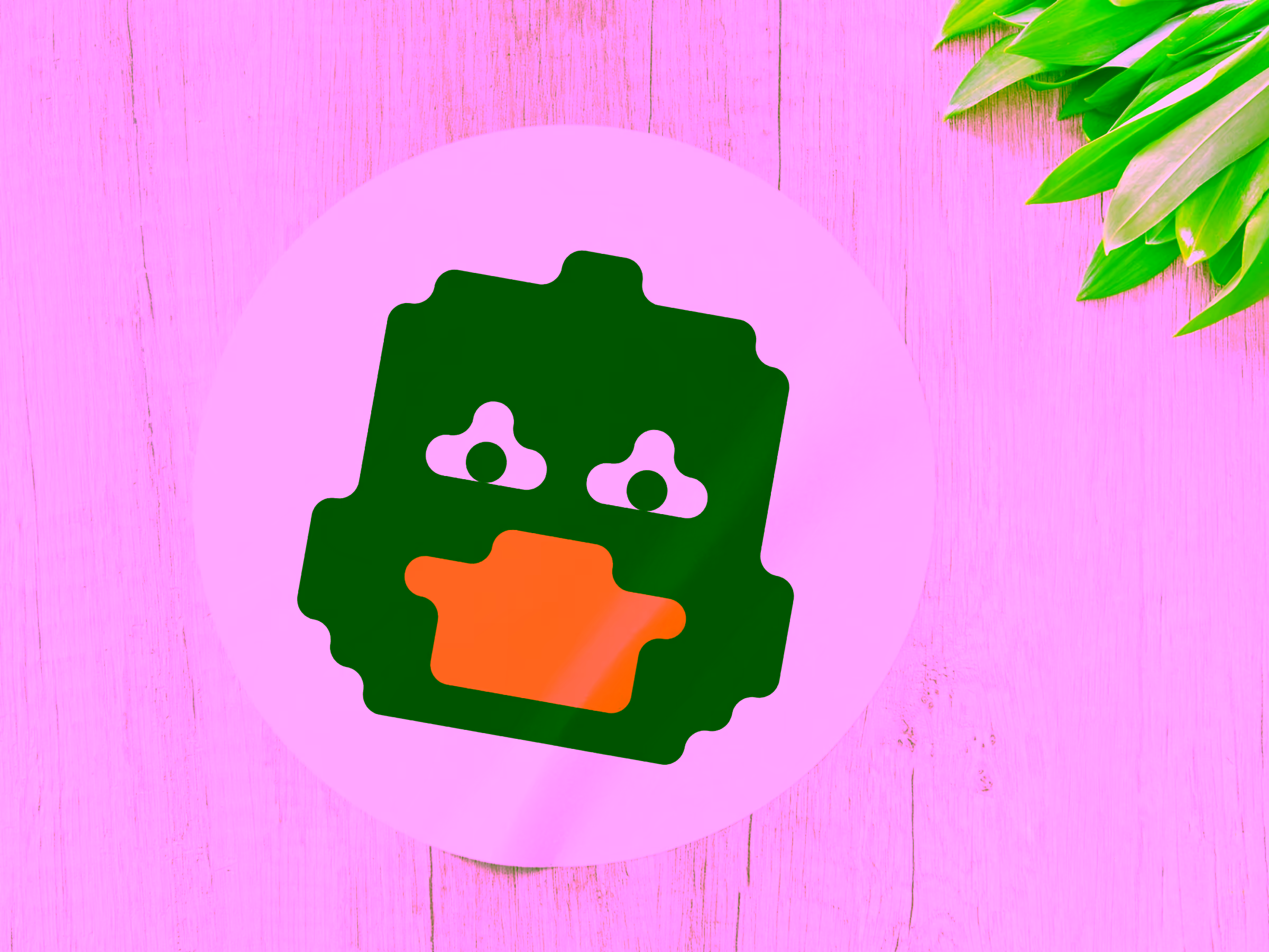 Round sticker with a stylized black duck head featuring white eyes and an orange beak on light wood background with green leaves at the top right.