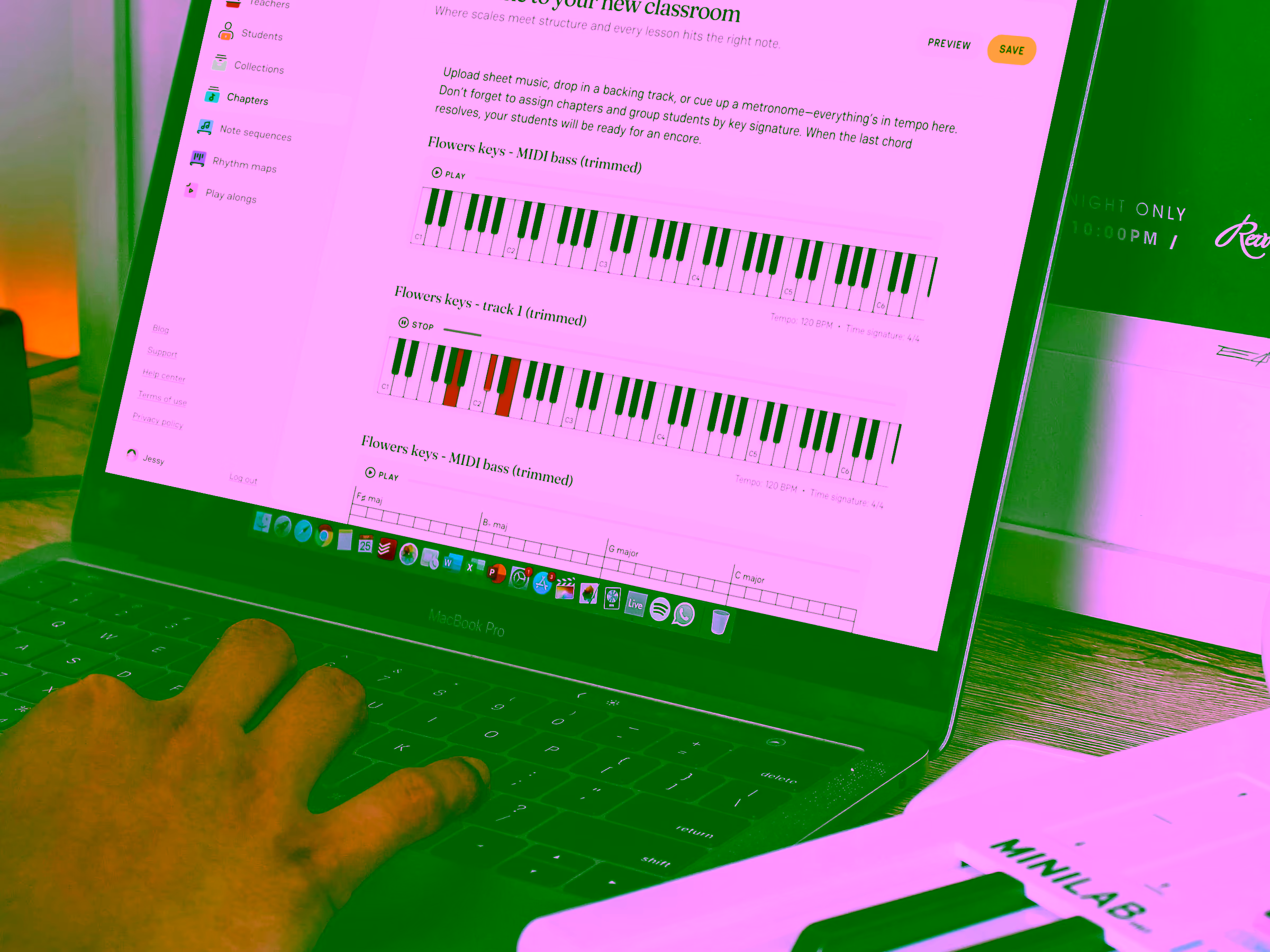 Person using a MacBook Pro displaying music lesson software with piano keyboard visuals and playback controls.