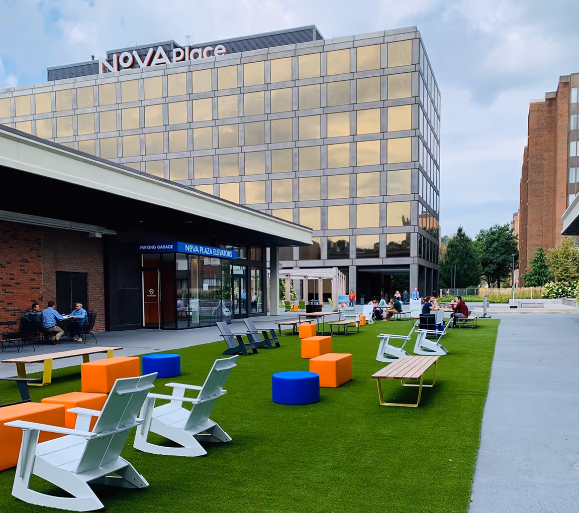 lawn chairs on green space outside of Nova Place building on campus