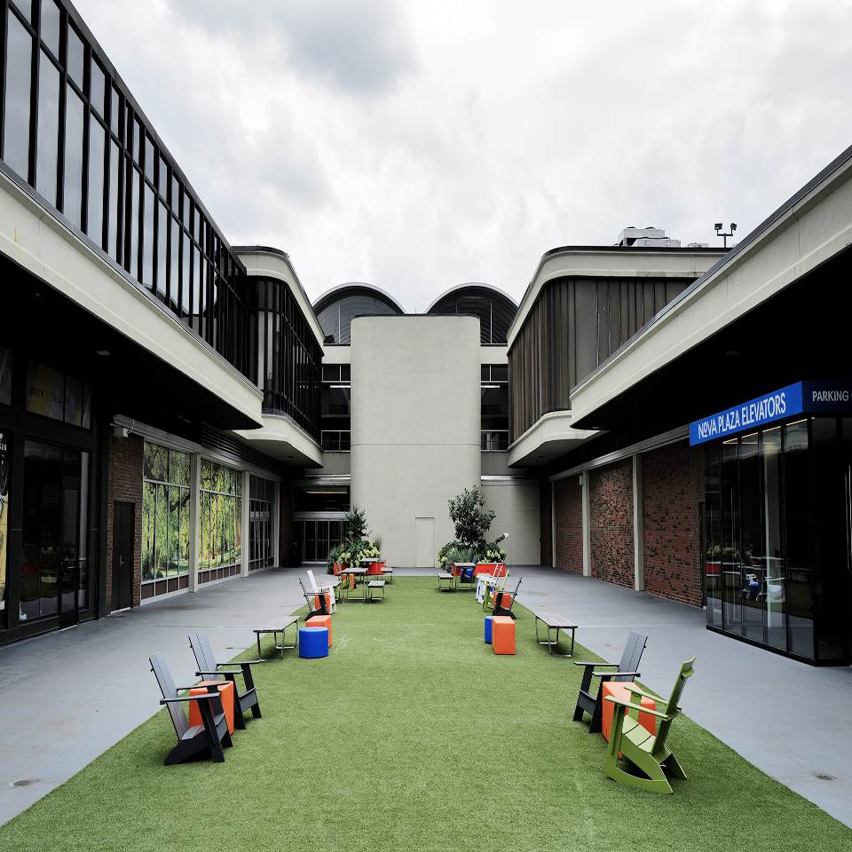 lawn chairs placed along outdoor common green space at Nova Place