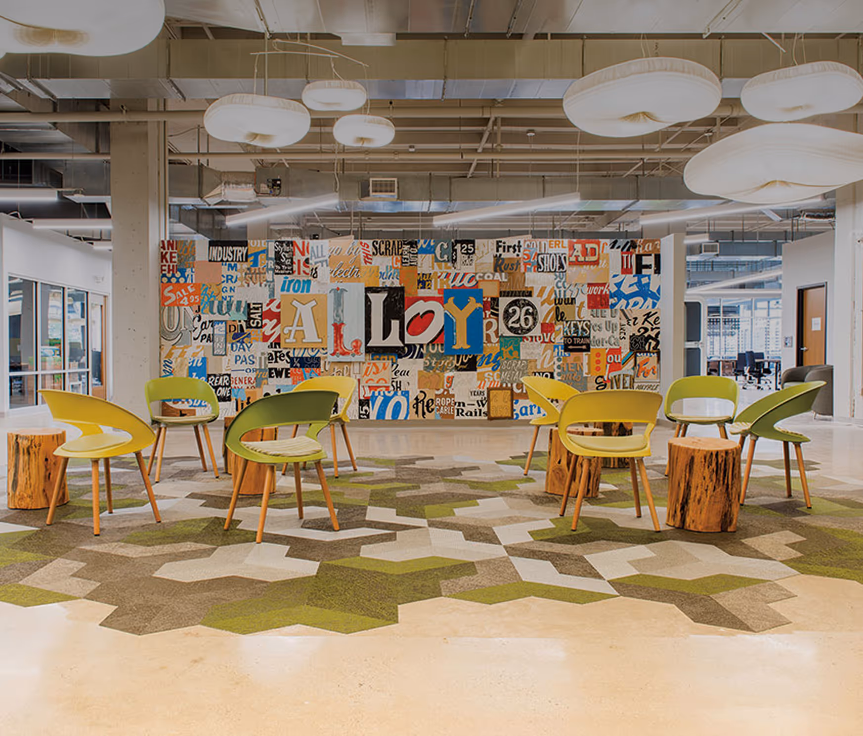 vibrant coworking area with yellow and green modern chairs at Alloy 26 at Nova Place