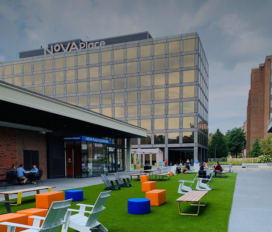 lawn chairs spread out on common green space on Nova Place campus