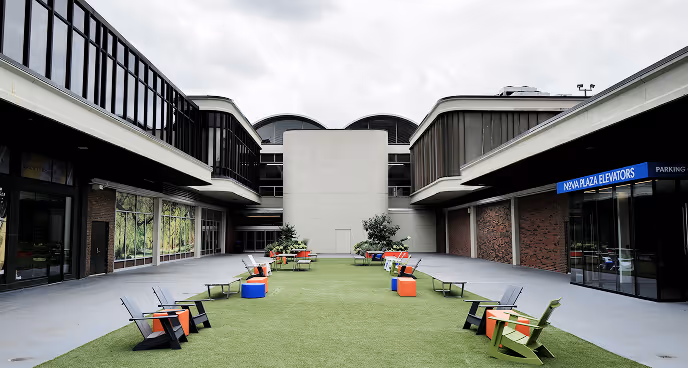 lawn chairs spaced out on common green space on Nova Place campus