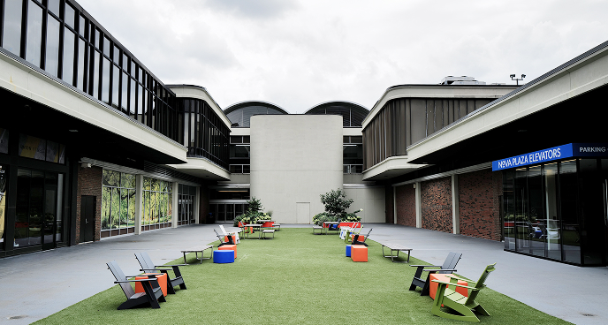 lawn chairs spaced out on common green space on Nova Place campus