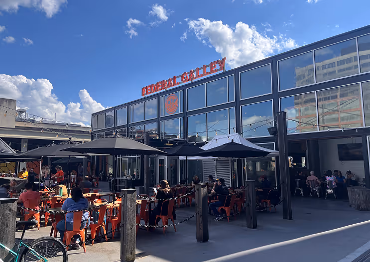 People sitting at tables outside of Federal Galley