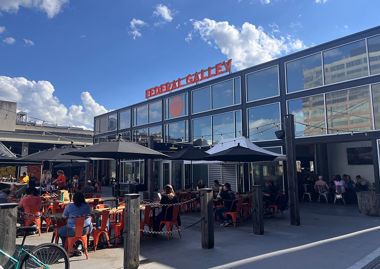 People sitting at tables outside of Federal Galley