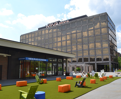 lawn chairs on greenery outside of Nova Place office building on campus
