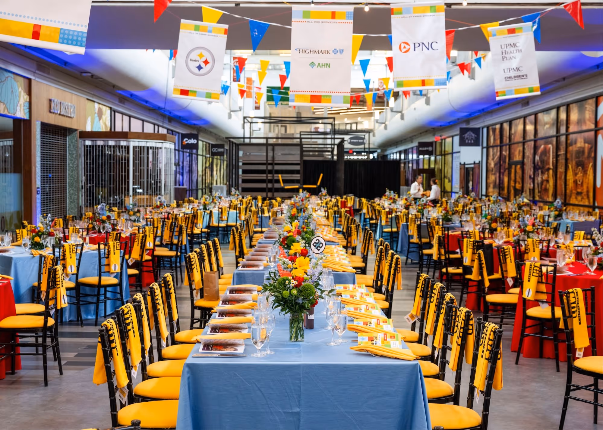 Image of concourse decorated for an event with long tables and many chairs.