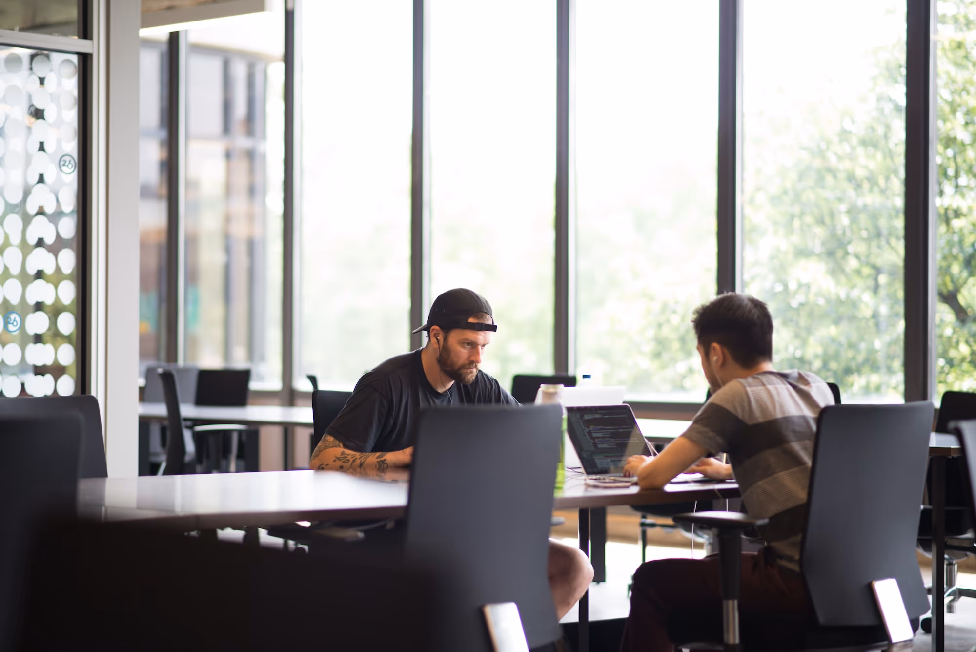Image of 2 men working at desks.