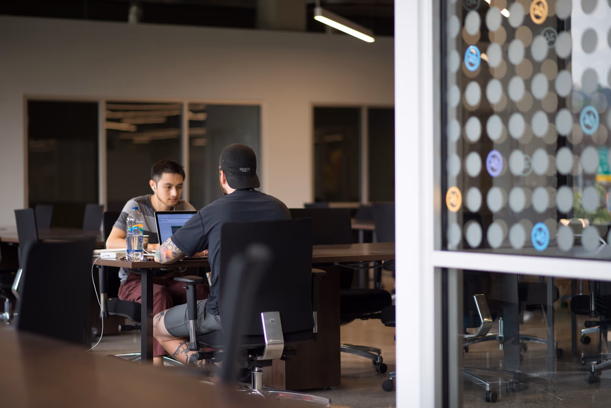 Image of 2 men working at desks.