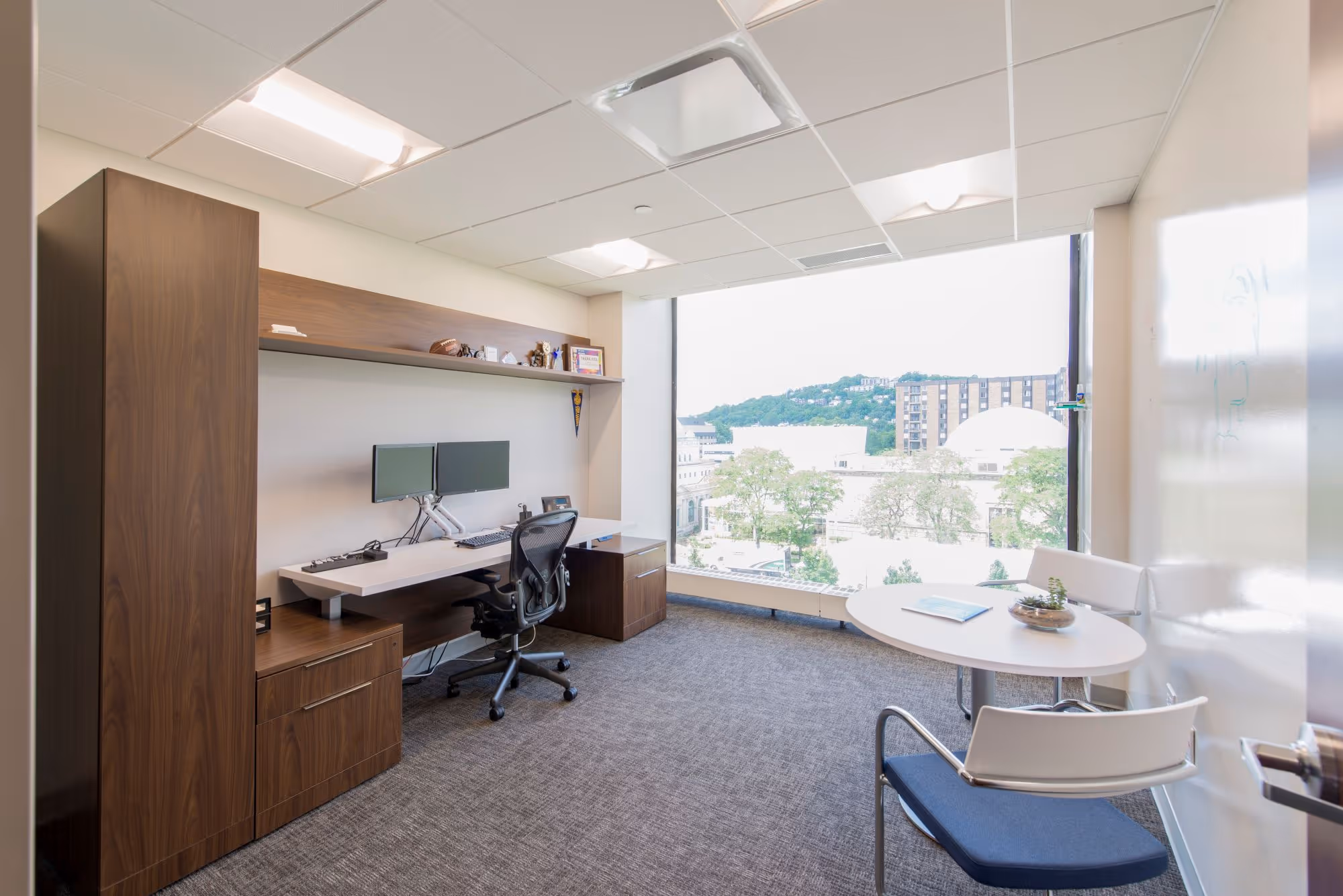 Image of an office space with large windows. 