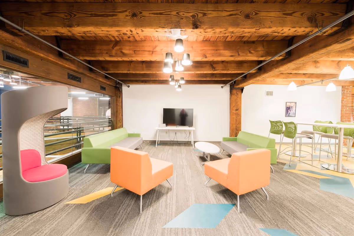 office lounge area with colorful modern chairs and conference tables