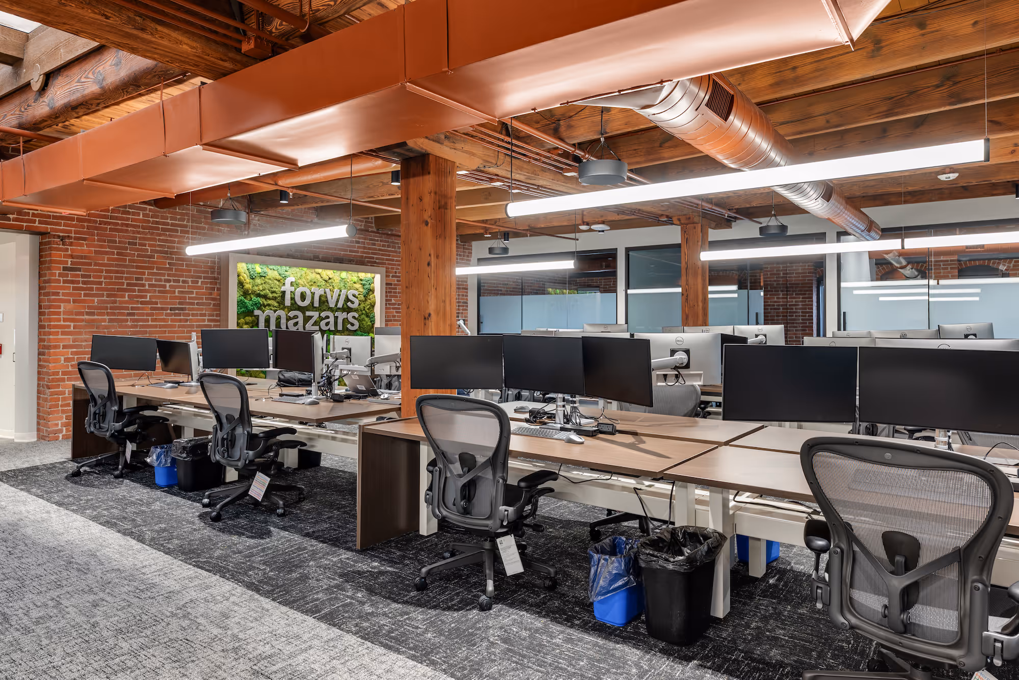 Photo of empty desks and workspaces in a co-working environment