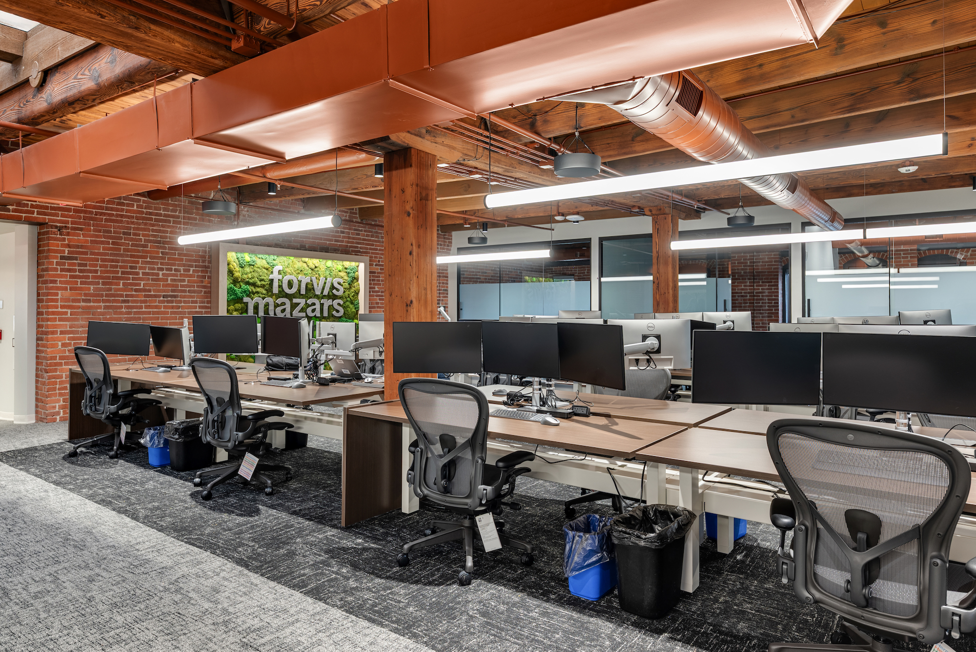 Photo of empty desks and workspaces in a co-working environment