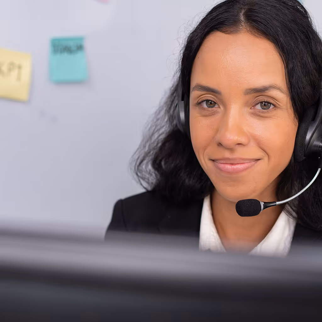 Woman in a blue blazer in front of a colorful film and media-themed background with popcorn and movie reels