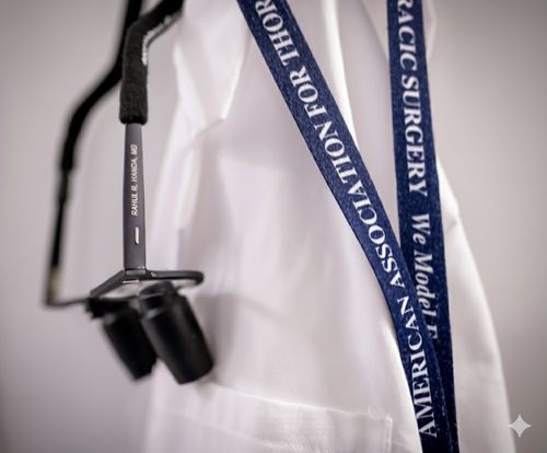 Close-up of a white coat with a stethoscope labeled 'RAHUL R. PANDA, MD' and a blue lanyard reading 'AMERICAN ASSOCIATION FOR THORACIC SURGERY'.